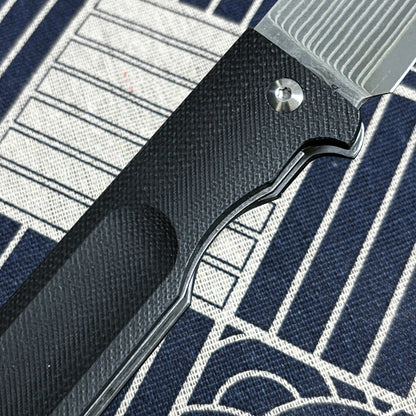 Japanese-origin Takeshi Saji Folding Knife: Damascus SG2 Powdered Steel, Handcrafted, G10 Handle.