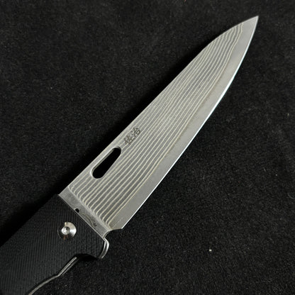 Japanese-origin Takeshi Saji Folding Knife: Damascus SG2 Powdered Steel, Handcrafted, G10 Handle.